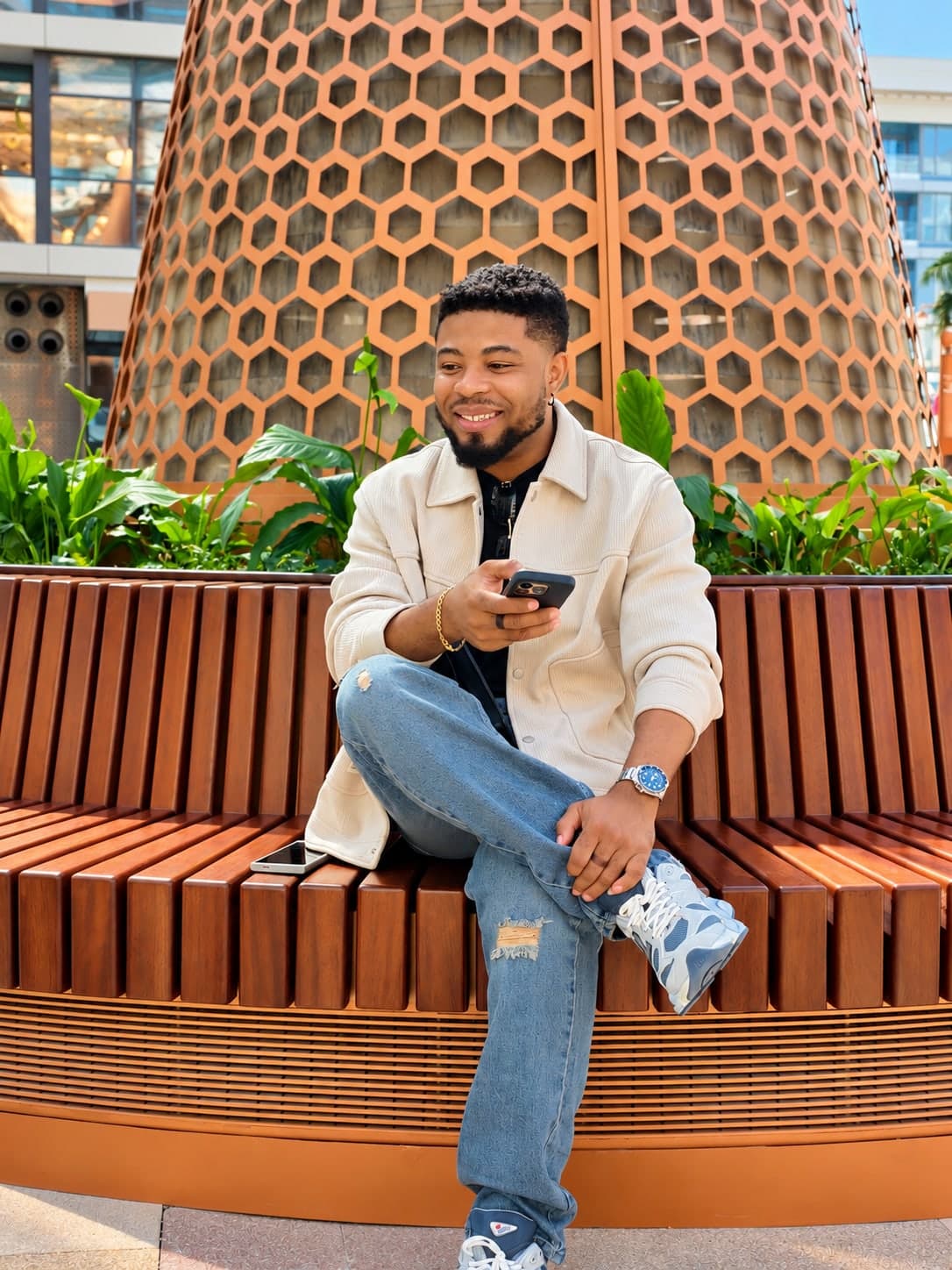 Oscar Frank on a bench with his phone