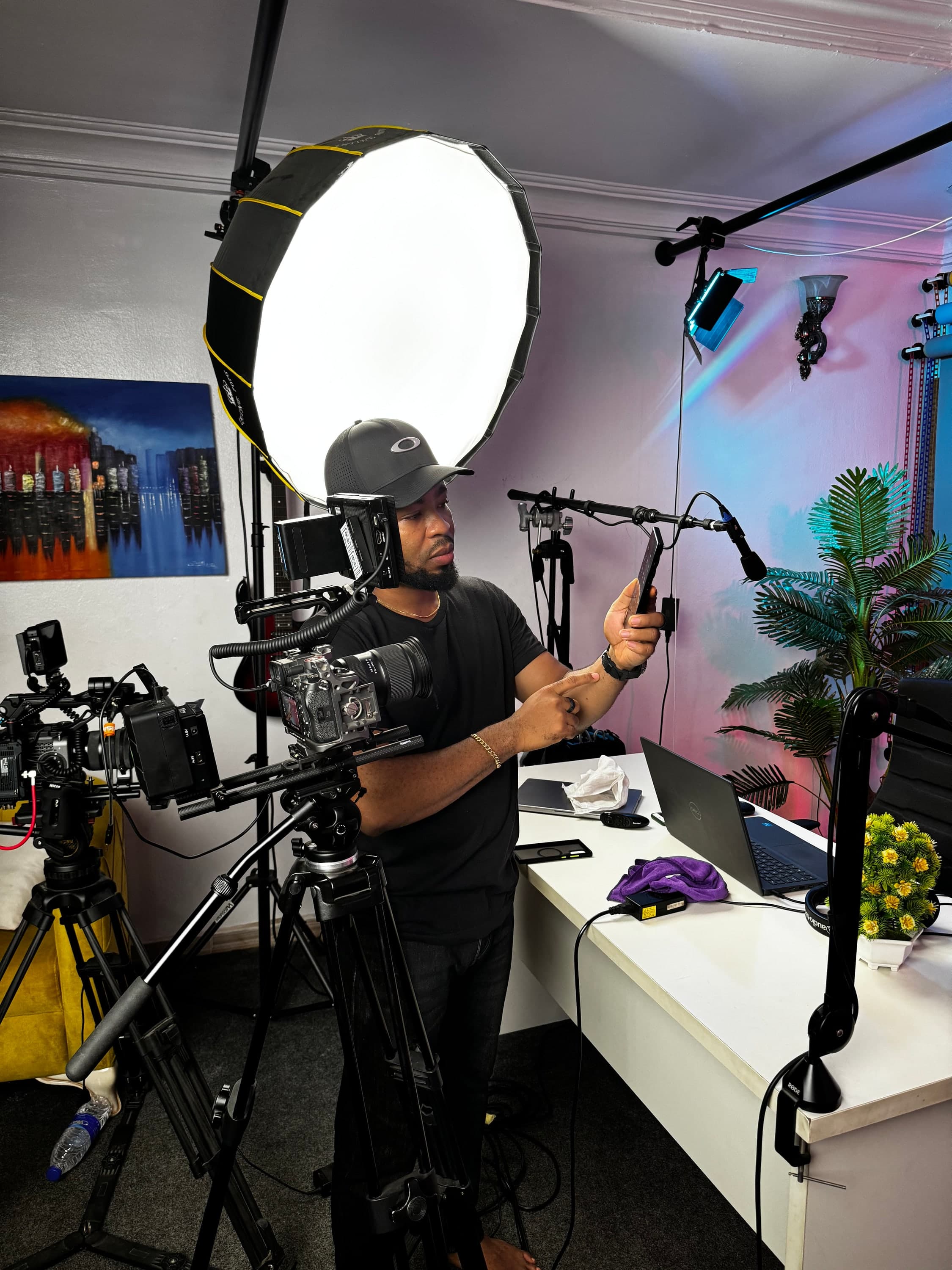 Oscar Frank setting up cameras and lights in the studio
